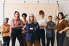 a group of 7 women, each striking a confident pose.