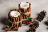 homemade white candles surrounded by cinnamon sticks and tied with twine.